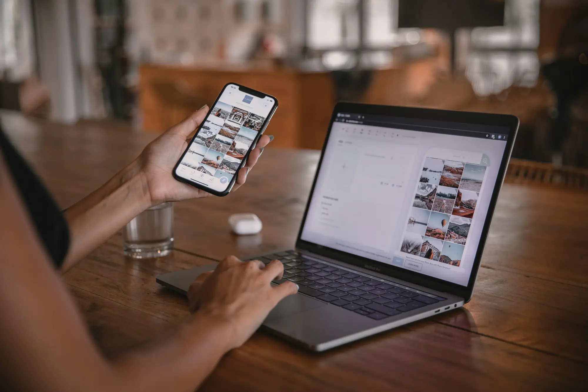 Person at a cafe table holding a smartphone